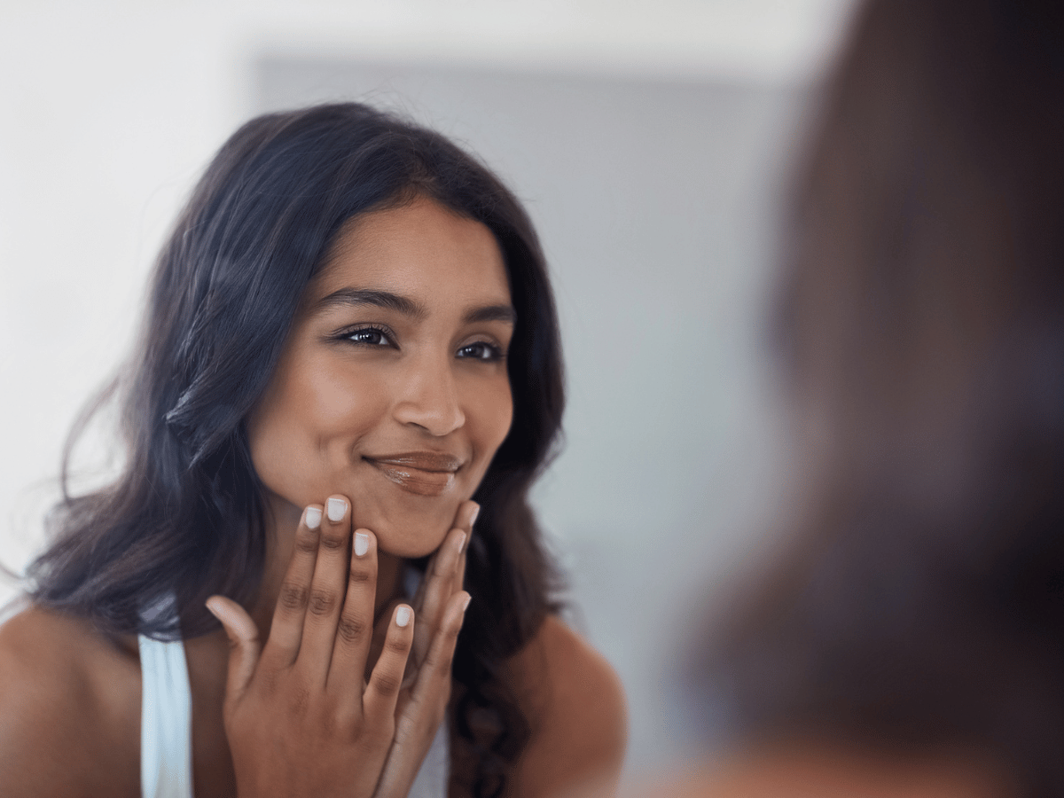 happy woman smiling in mirror