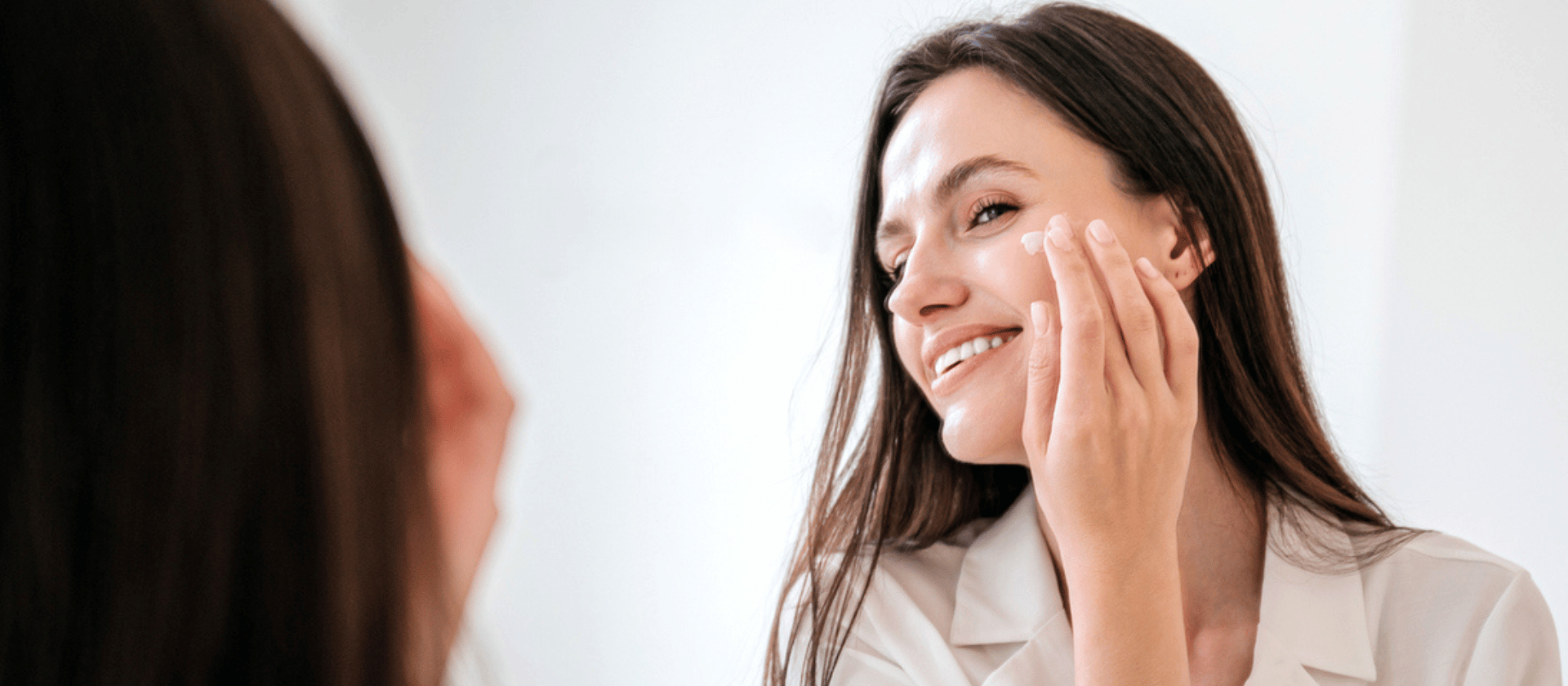 smiling woman looking in the mirror