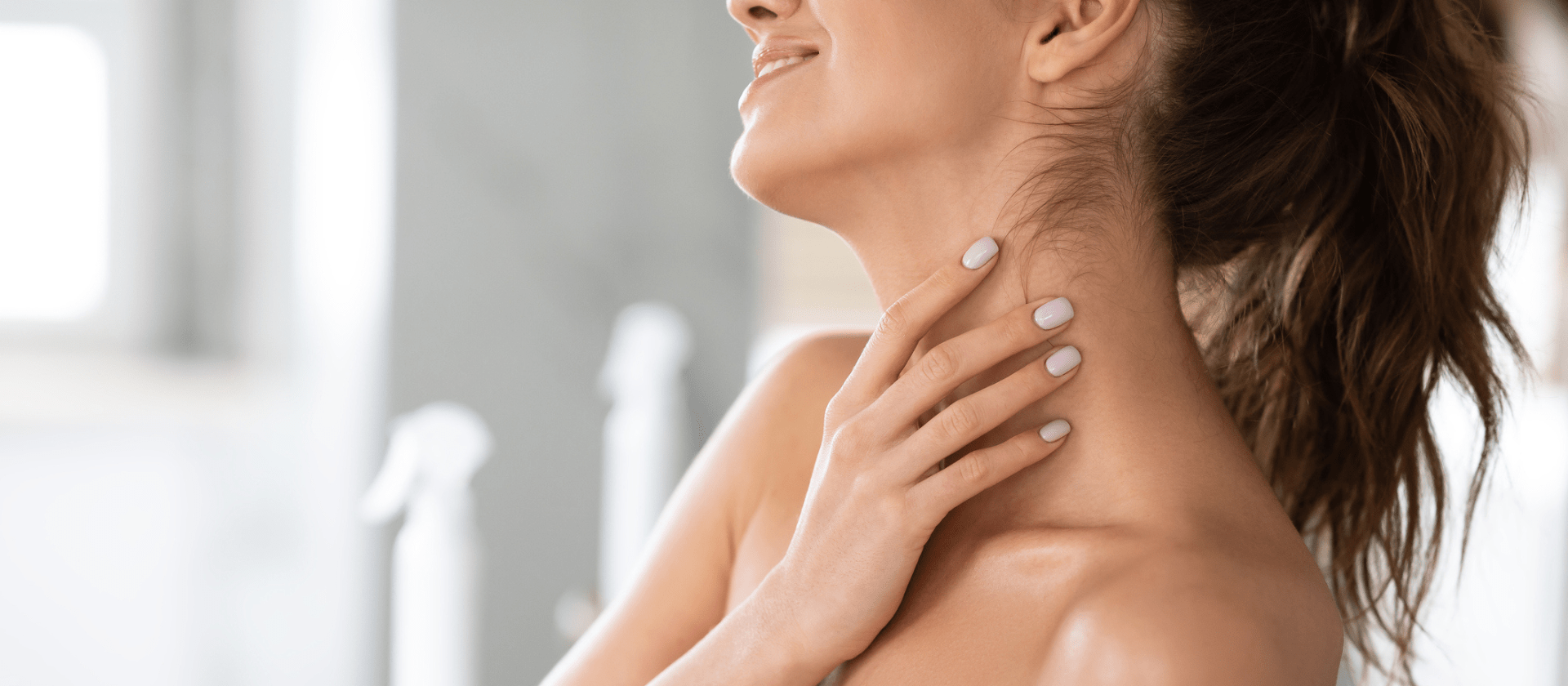 woman touching her neck